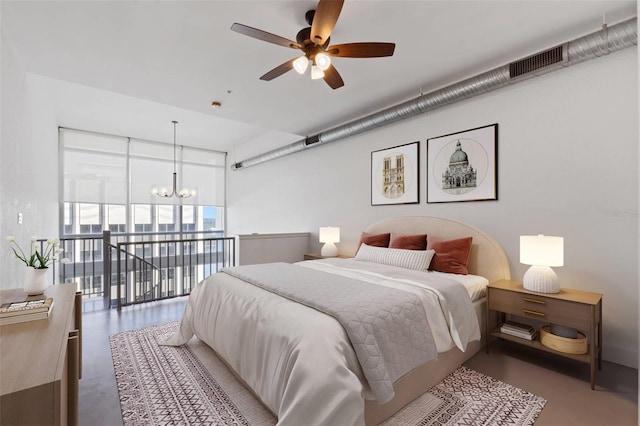 bedroom with ceiling fan with notable chandelier and a wall of windows