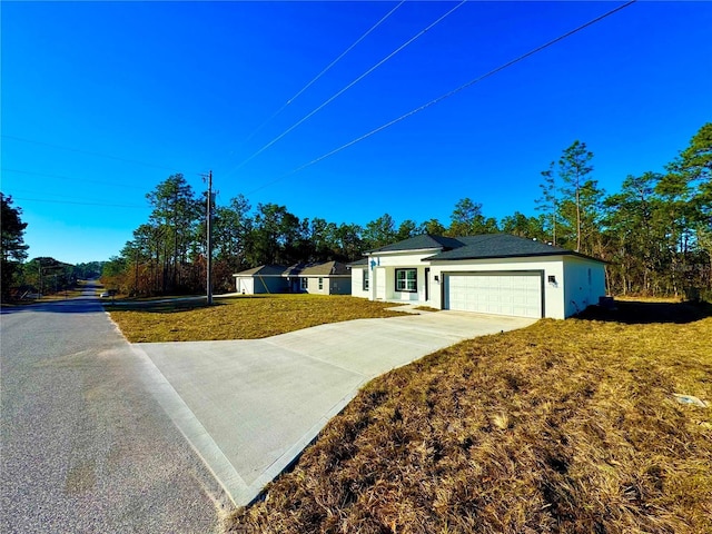 single story home with a front yard and a garage