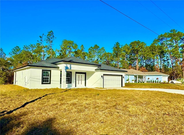 view of front facade featuring a garage and a front lawn