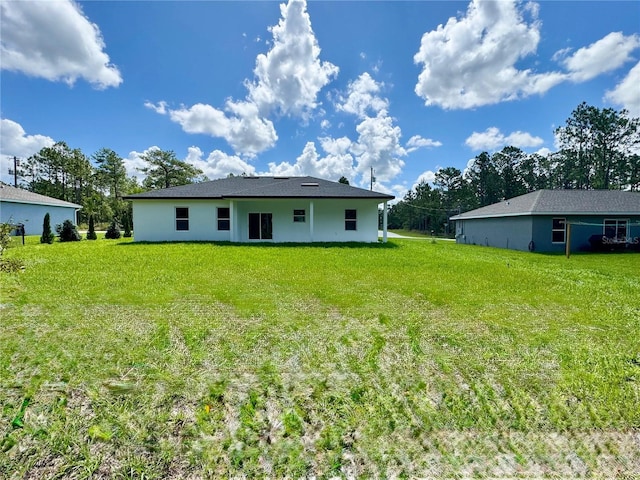 7362 N Everest Ter, Citrus Springs, FL 34434 - back of property with a lawn and stucco siding