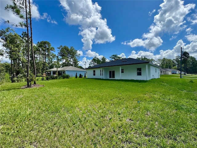 7362 N Everest Ter, Citrus Springs, FL 34434 - back of house featuring a yard and stucco siding