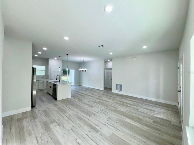 7362 N Everest Ter, Citrus Springs, FL 34434 - unfurnished living room with recessed lighting, light wood-type flooring, and a chandelier