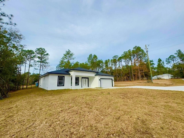 exterior space featuring a front yard and a garage