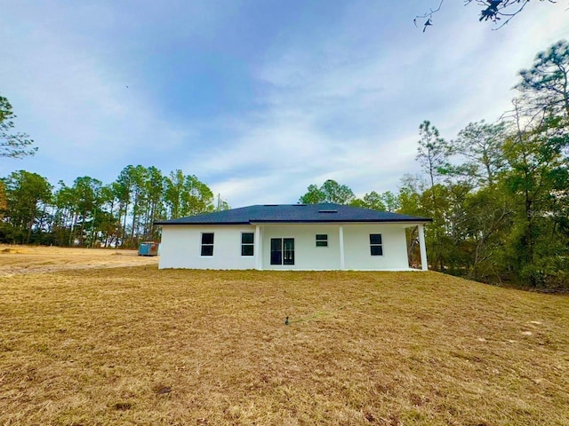 back of house with a lawn