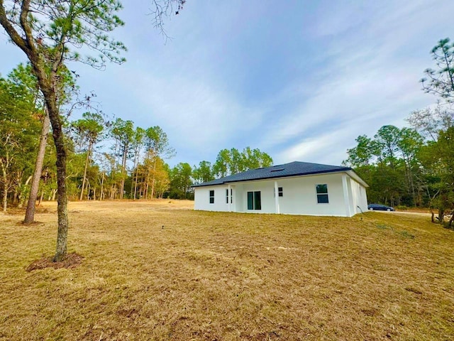 back of house featuring a yard