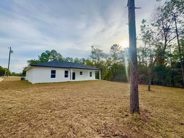 back of house with a lawn