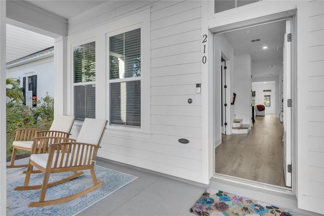 view of exterior entry with covered porch