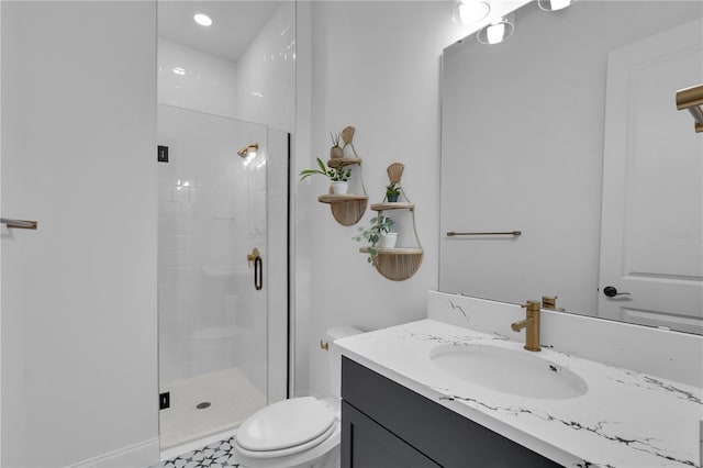 bathroom with tile patterned floors, toilet, vanity, and walk in shower