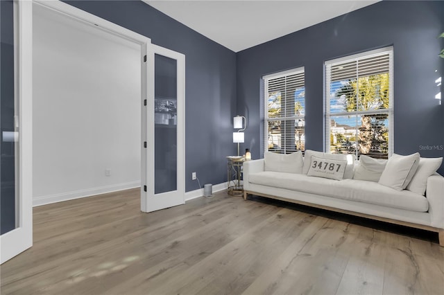 interior space with french doors and light hardwood / wood-style flooring