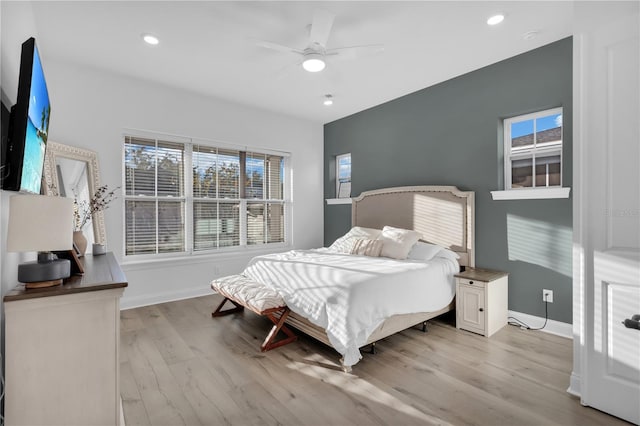 bedroom with ceiling fan and light hardwood / wood-style floors