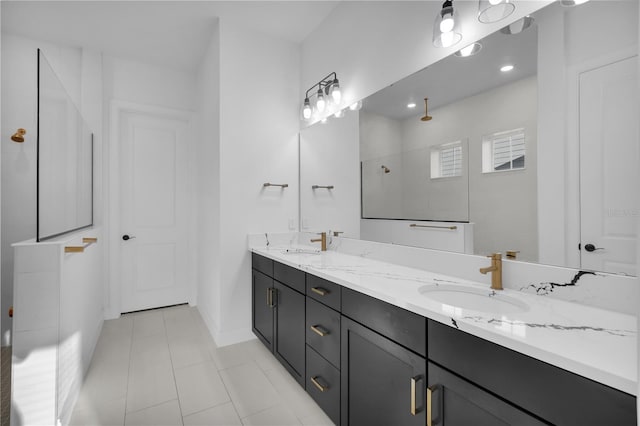 bathroom with tile patterned flooring, vanity, and walk in shower