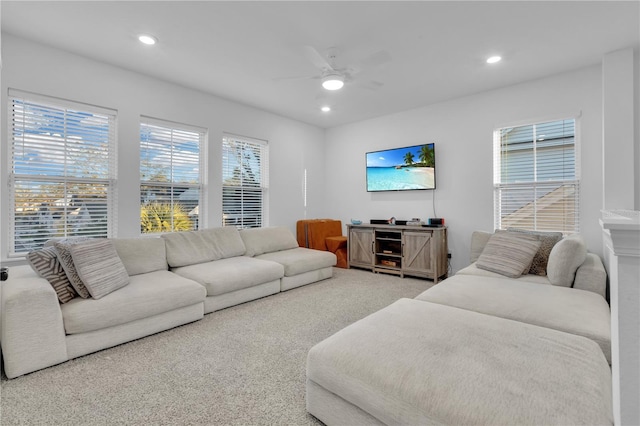 carpeted living room with ceiling fan