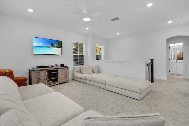 carpeted living room with ceiling fan