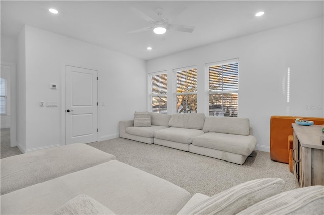 living room featuring light carpet and ceiling fan