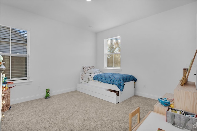 bedroom featuring light carpet