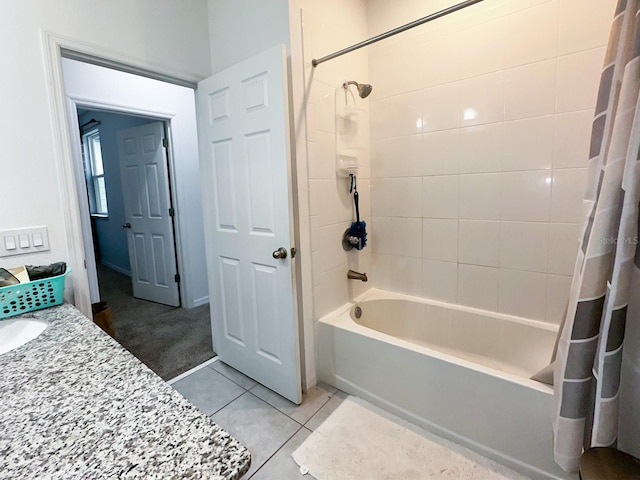 bathroom with shower / bath combo, tile patterned flooring, and vanity