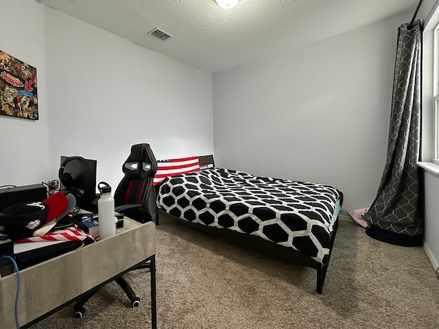 bedroom featuring carpet and a textured ceiling