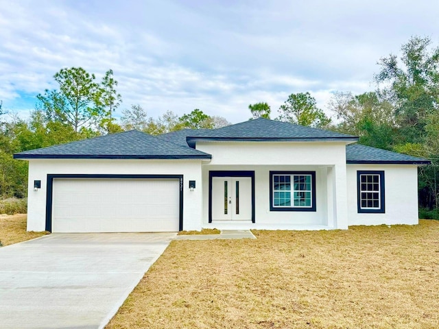 view of front of home featuring a front lawn and a garage