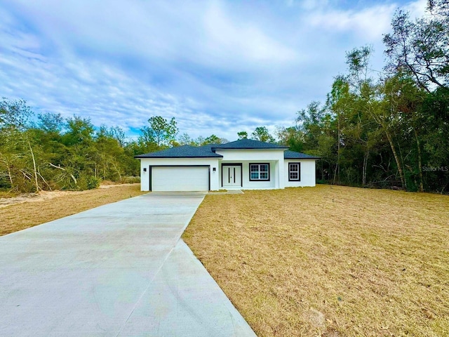 view of front of house featuring a front yard and a garage