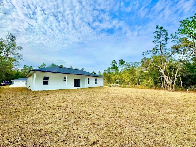 rear view of property with a lawn