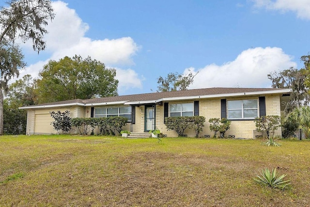 ranch-style home with a front yard and a garage