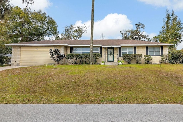 ranch-style home featuring a garage and a front lawn