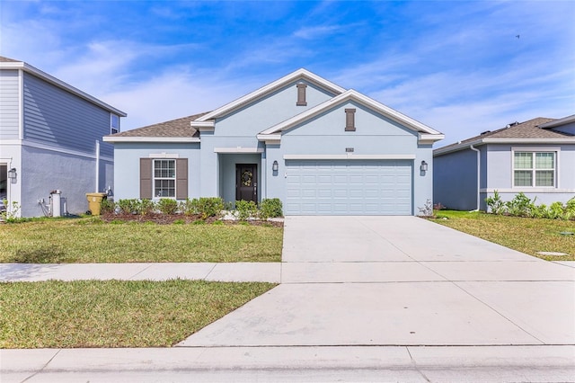 view of front of home with a front lawn and a garage