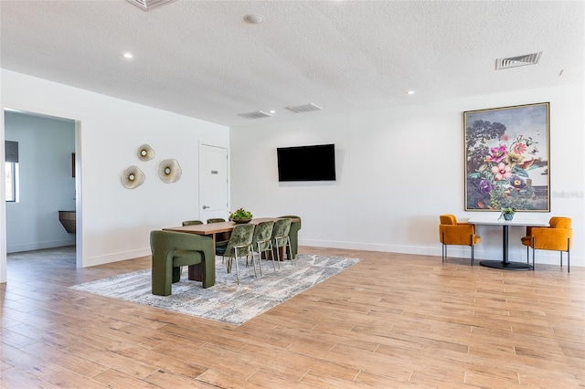 dining space with a textured ceiling