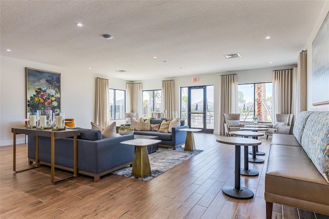 living room featuring a textured ceiling and french doors