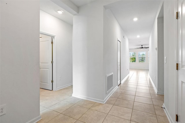 corridor featuring light tile patterned floors