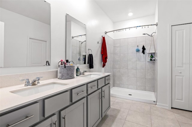 bathroom featuring vanity, tile patterned flooring, and tiled shower