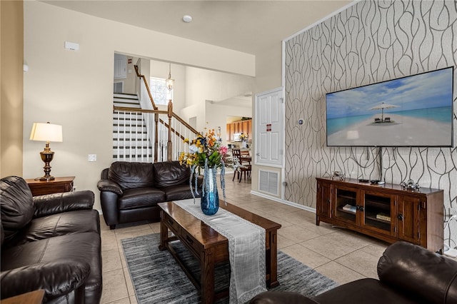 living room featuring light tile patterned floors and a notable chandelier