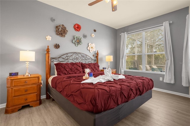 bedroom with light hardwood / wood-style flooring and ceiling fan