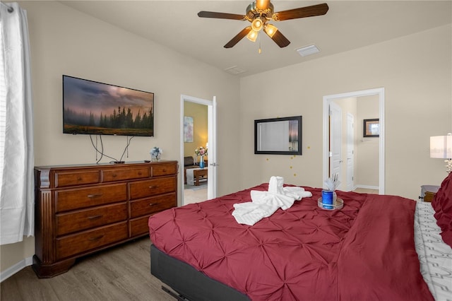 bedroom featuring connected bathroom, light hardwood / wood-style flooring, and ceiling fan