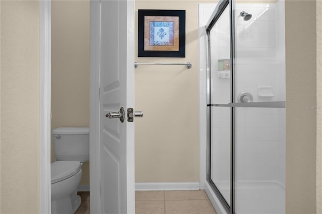 bathroom with tile patterned floors, an enclosed shower, and toilet