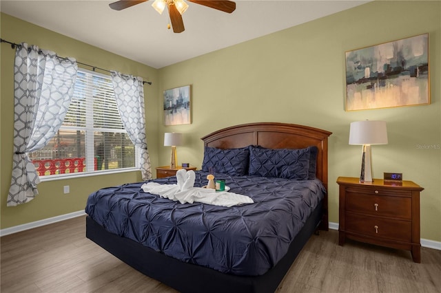 bedroom with hardwood / wood-style flooring and ceiling fan