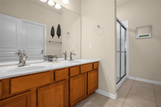 bathroom with tile patterned floors, vanity, and walk in shower