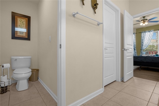 bathroom with tile patterned floors, ceiling fan, and toilet