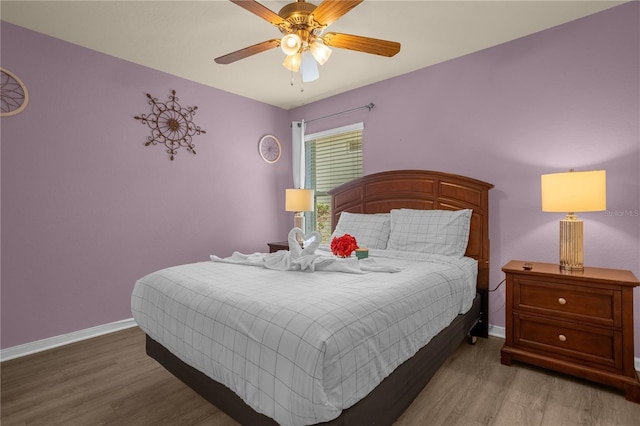 bedroom with hardwood / wood-style flooring and ceiling fan