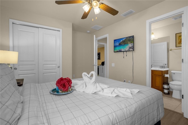 bedroom featuring connected bathroom, a closet, ceiling fan, and light hardwood / wood-style floors