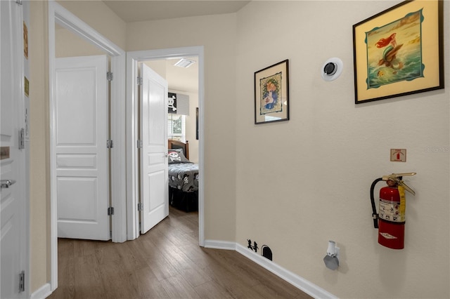 corridor featuring wood-type flooring