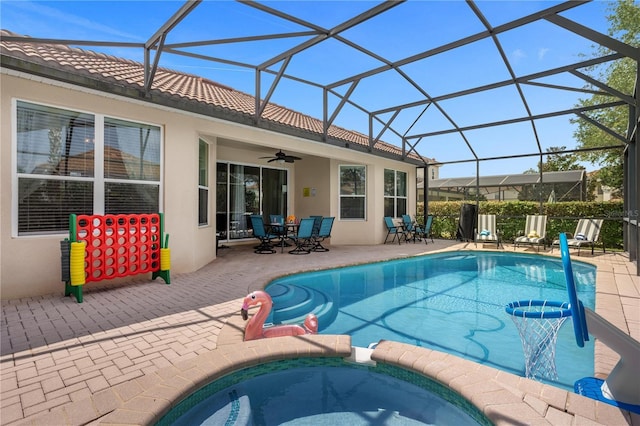 view of pool featuring ceiling fan, a lanai, an in ground hot tub, and a patio