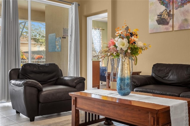 living room with a wealth of natural light and light tile patterned flooring