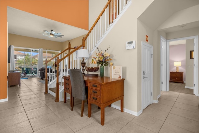 stairs featuring tile patterned floors and ceiling fan