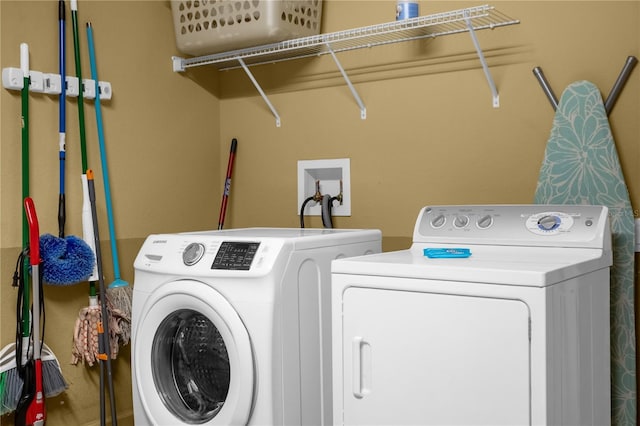 washroom with washing machine and clothes dryer