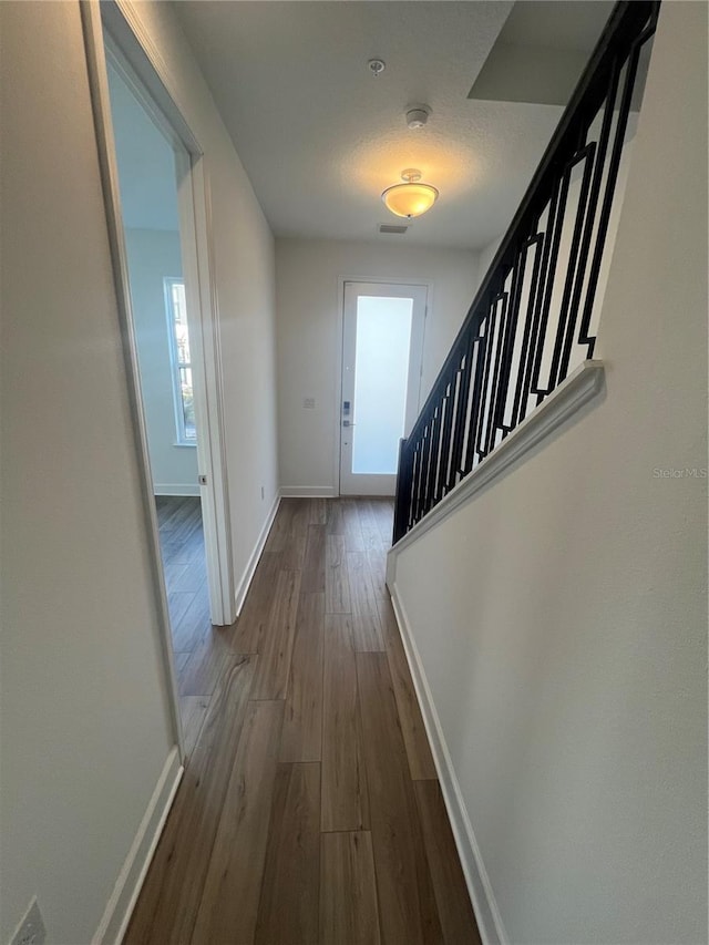 corridor featuring wood-type flooring