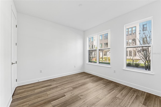 spare room featuring wood-type flooring