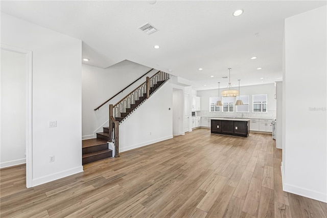 unfurnished living room featuring light hardwood / wood-style flooring