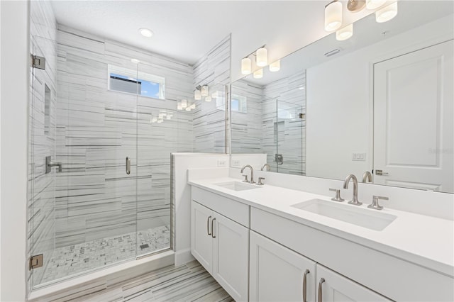 bathroom featuring walk in shower and vanity