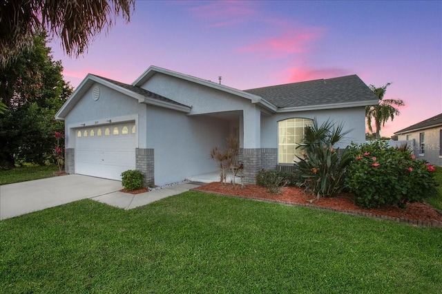 ranch-style home with a lawn and a garage